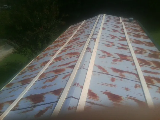 Rusted metal roof panels with new wood purlins before replacement — Storm Damage Roof Repair in Sandy Spring by Roofing Brothers